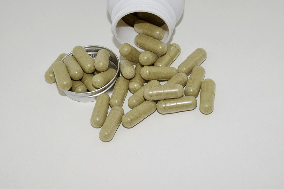 green capsules and a plastic container